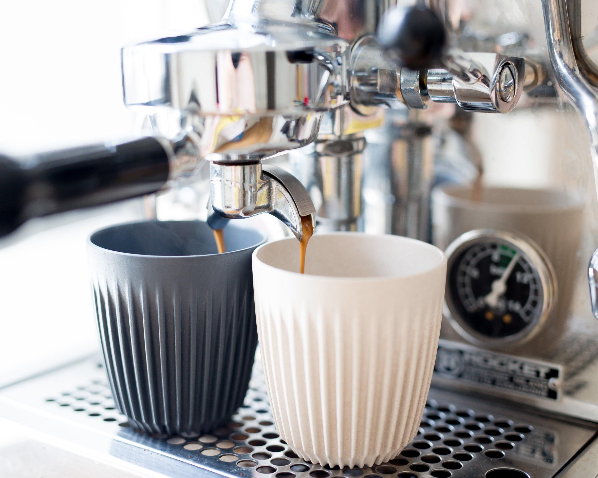 Eco-friendly coffee cups being filled from espresso machine, perfect for cafes and bulk orders