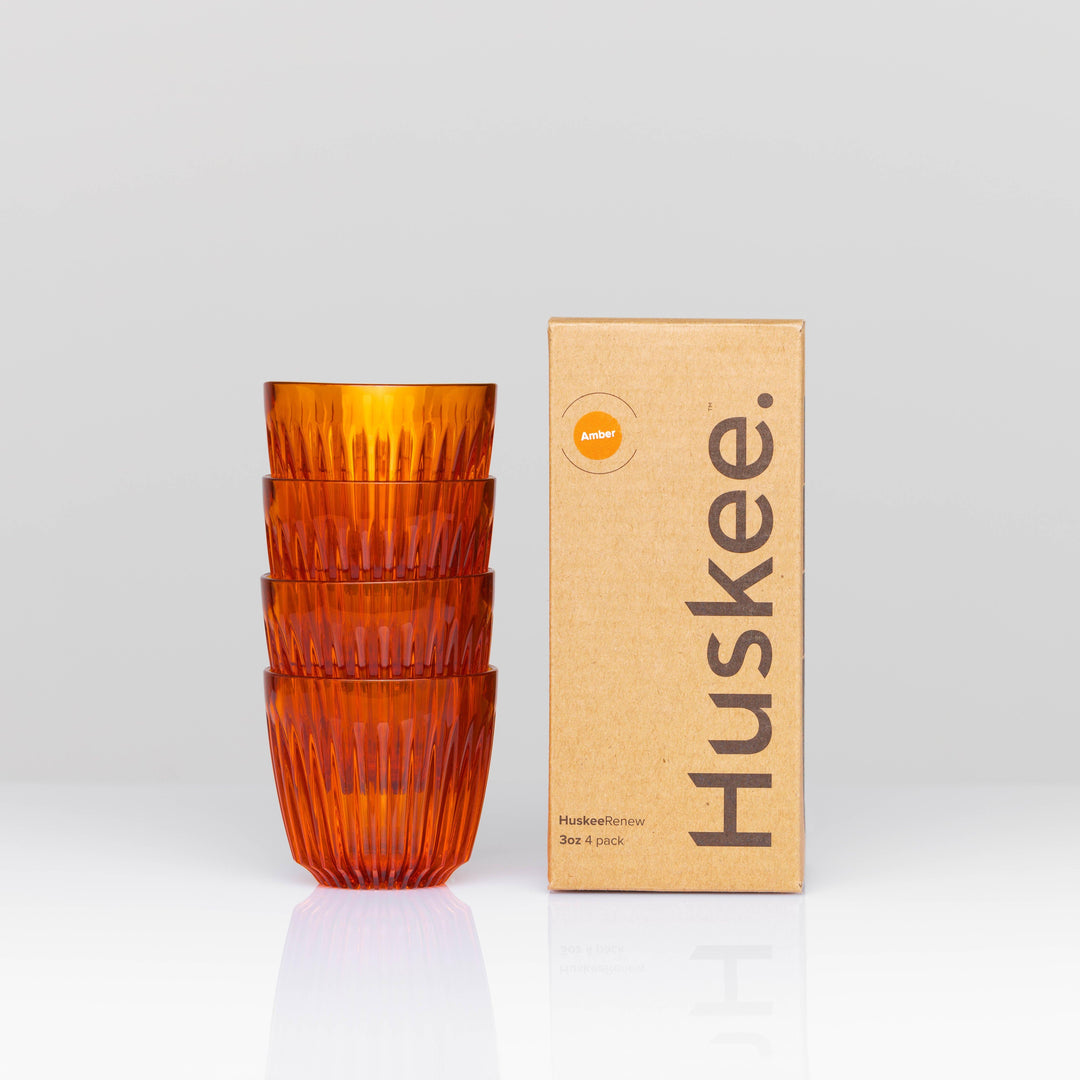Amber HuskeeRenew cups stacked beside box