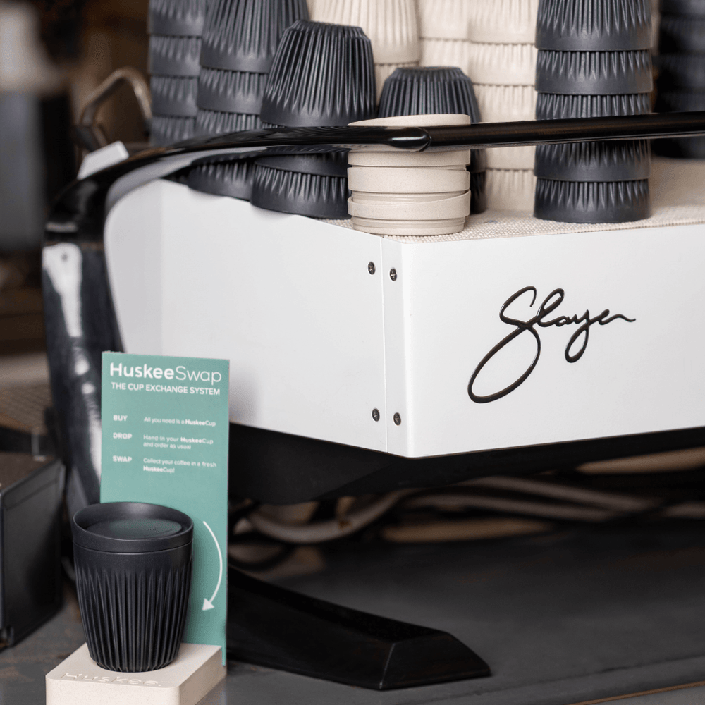 HuskeeSwap cups above espresso machine sign